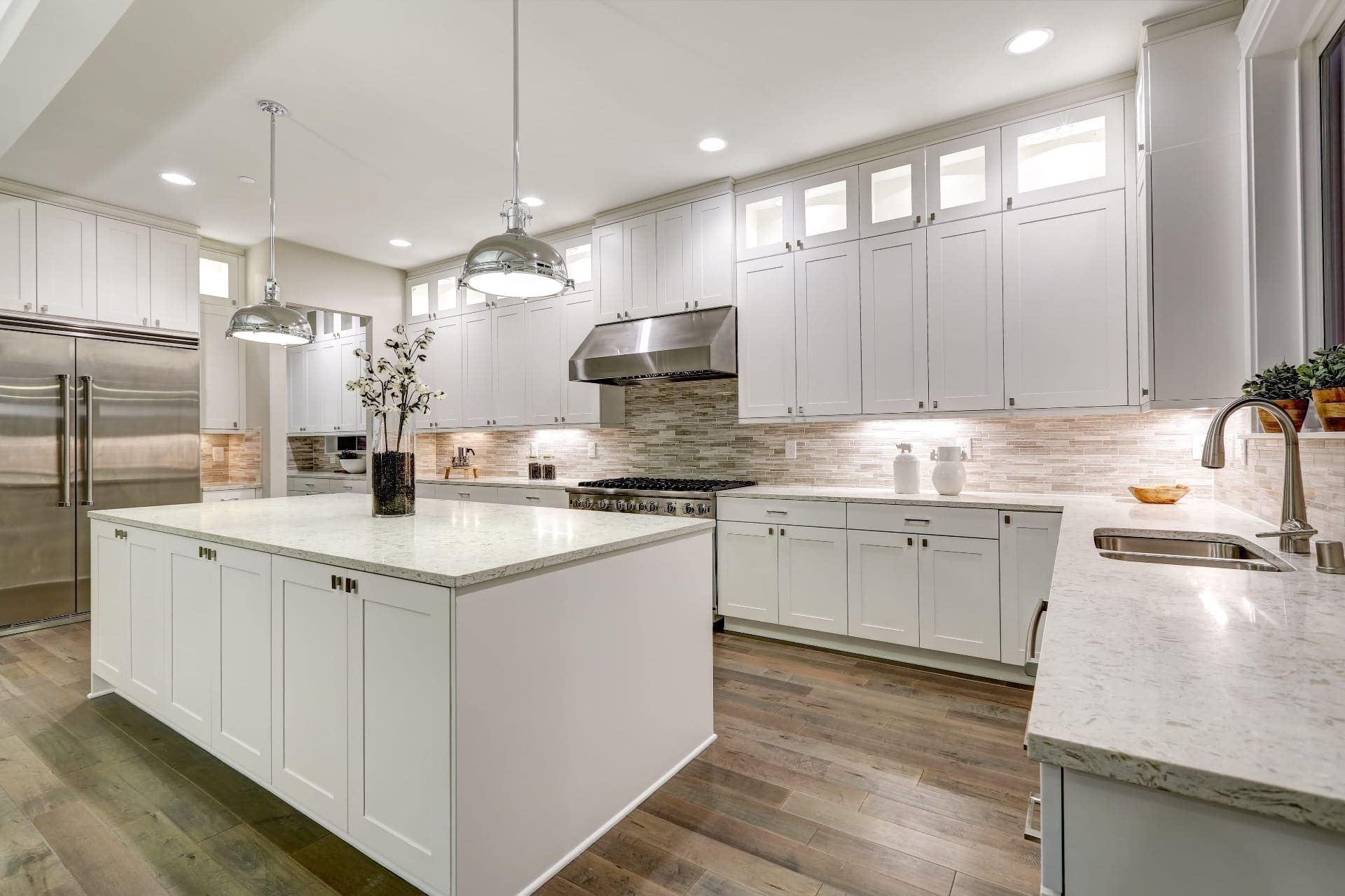Ardmore Kitchen Remodel in Ardmore, PA — Complete transformation of a dated kitchen into a modern, open-concept space with custom white cabinetry and marble countertops.